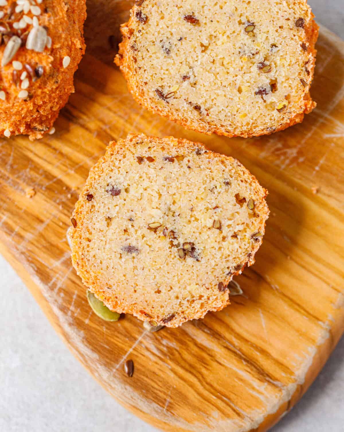 Sliced gluten-free lentil bread showing the soft interior crumb on a wooden cutting board