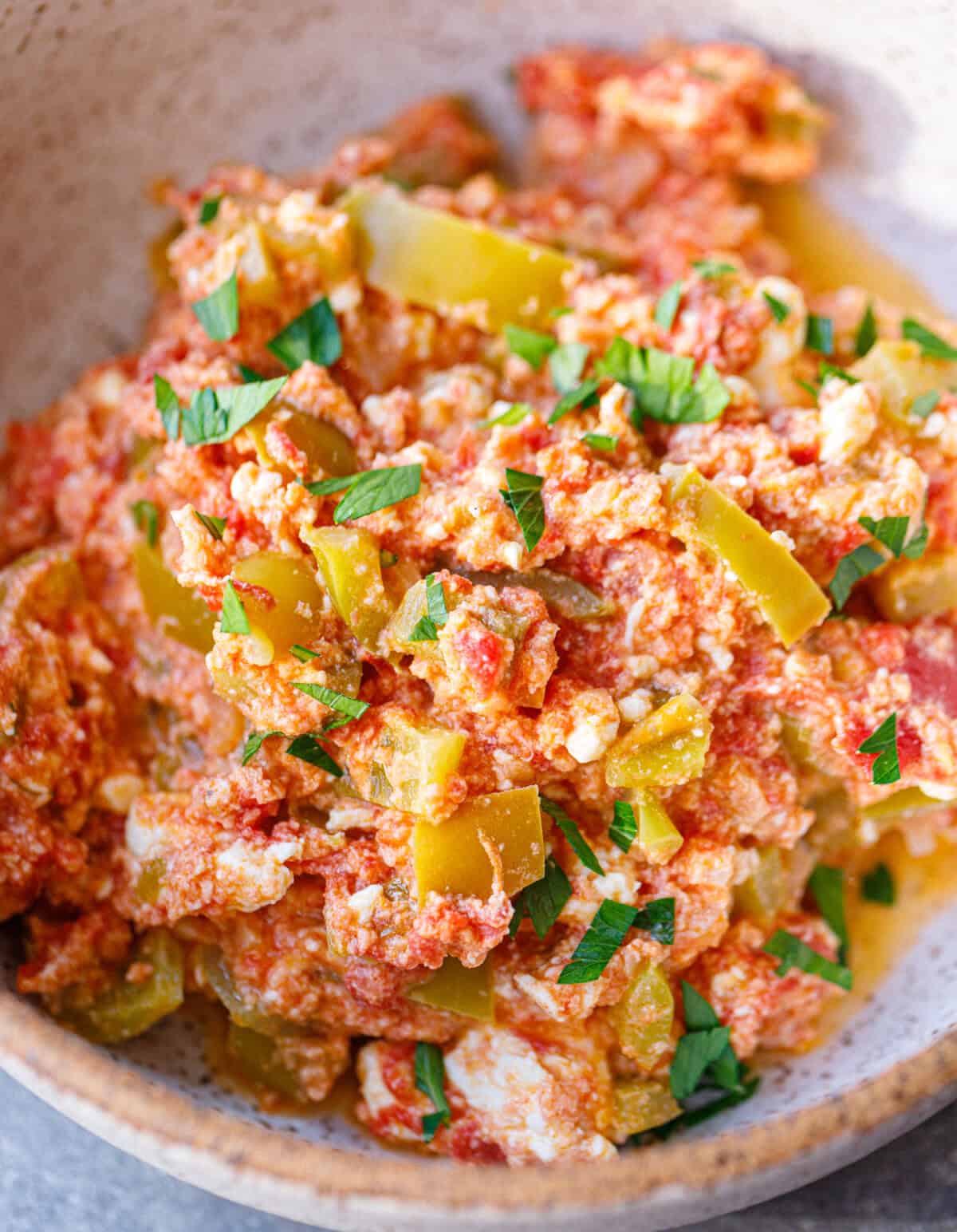 Bowl of Bulgarian mish mash topped with fresh parsley and crumbled feta