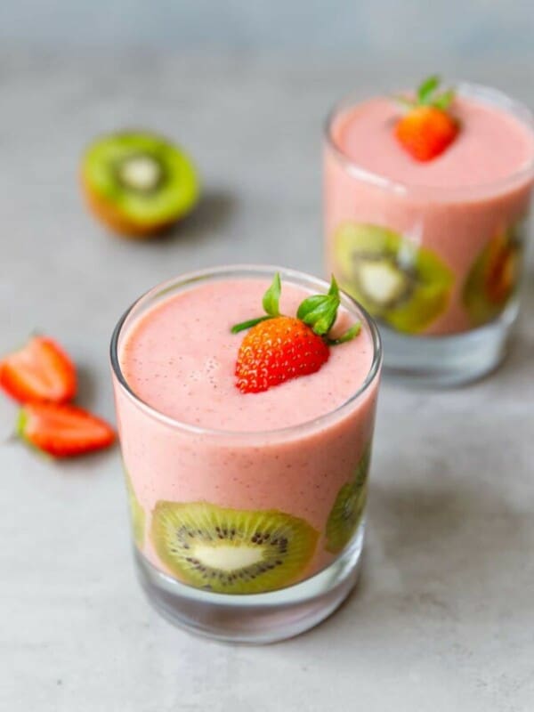 A clear glass with strawberry kiwi banana smoothie