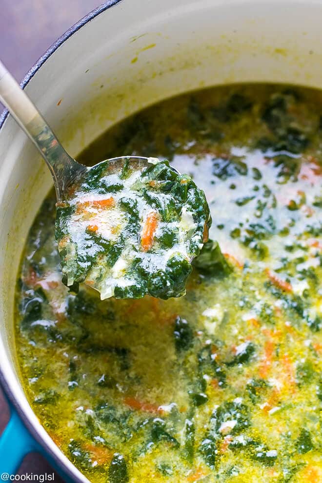 A pot full of fresh and delicious Bulgarian spinach egg drop soup. Ladle full of spinach soup with curdles egg whites.