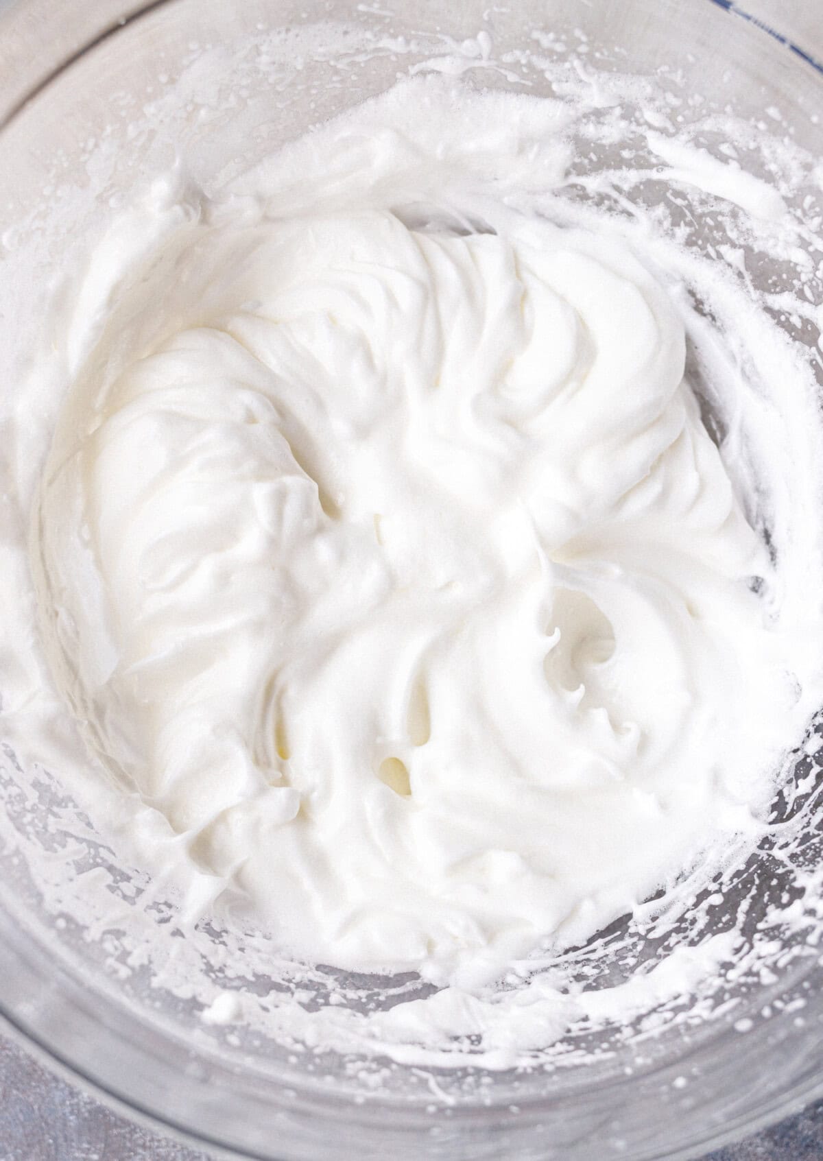 Egg whites whipped with sugar to firm peaks for a no bake yogurt cake
