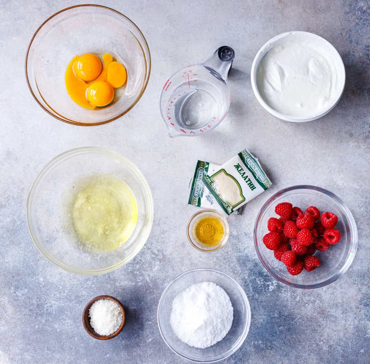 Ingredients for no bake yogurt cake — strained yogurt, eggs, gelatin, sugar, vanilla and fresh berries