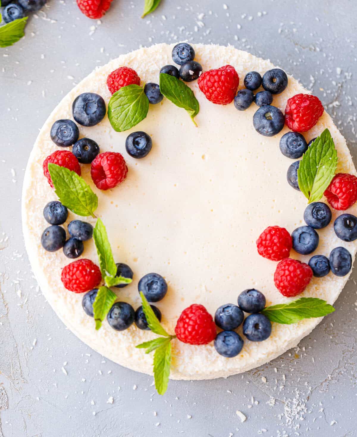 Bulgarian parfait — no bake yogurt cake decorated with a wreath of raspberries, blueberries and fresh mint