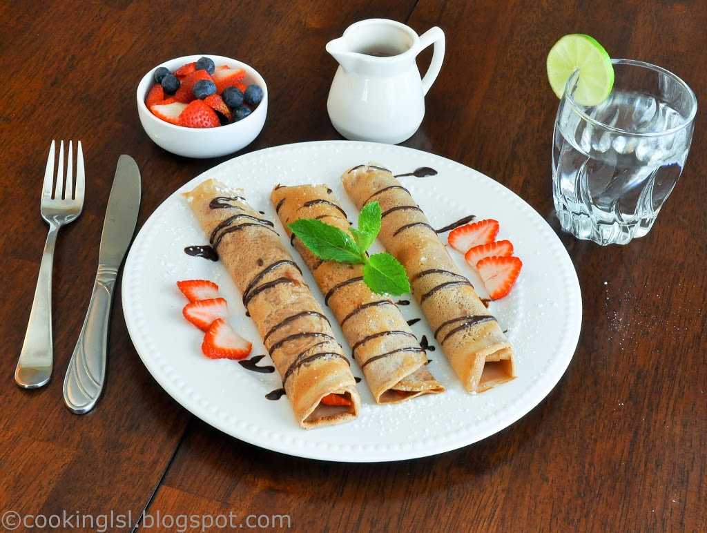 Chocolate crepes with fresh strawberries and chocolate sauce