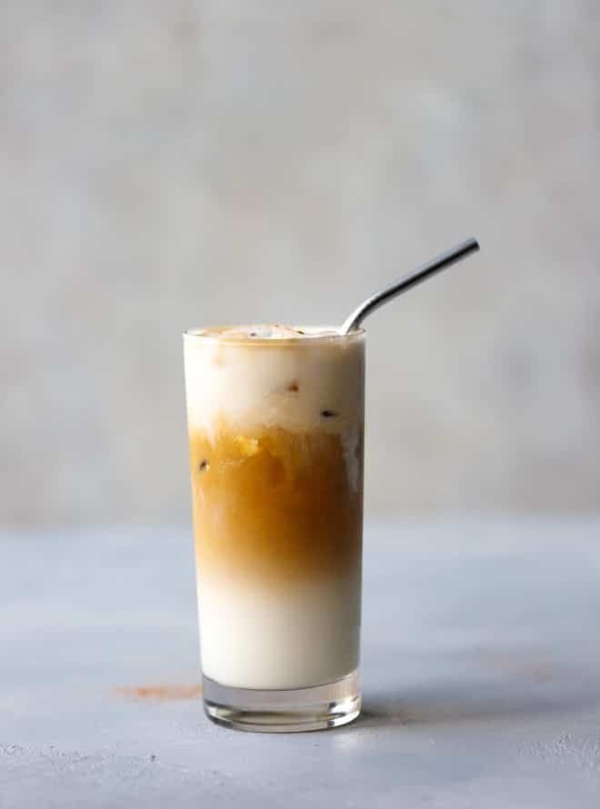 Iced Vanilla Coffee Latte Recipe Using Nespresso in a glass with a metal straw