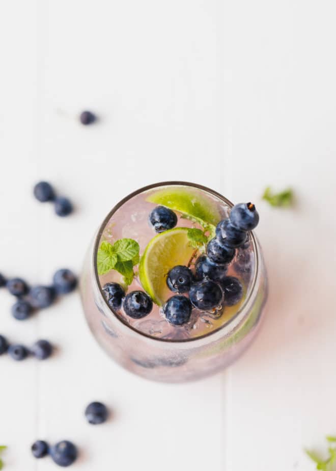 Blueberry mojito with fresh blueberries in a glass