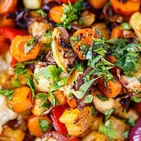Close-up of balsamic grilled vegetables with carrots, cherry tomatoes, red pepper and fresh herbs