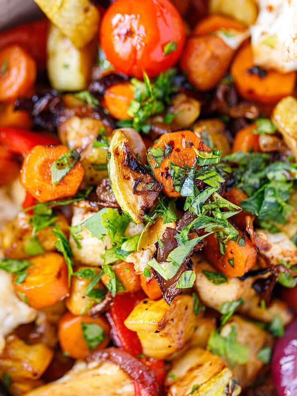 Close-up of balsamic grilled vegetables with carrots, cherry tomatoes, red pepper and fresh herbs