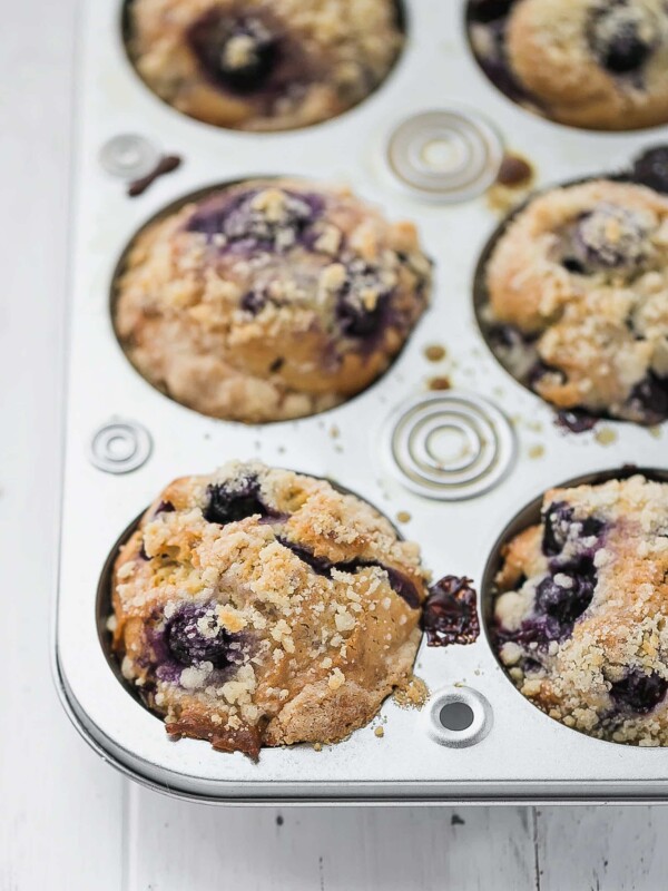 Blueberry Muffins With Olive Oil, Yogurt and Streusel Topping in a muffin tin