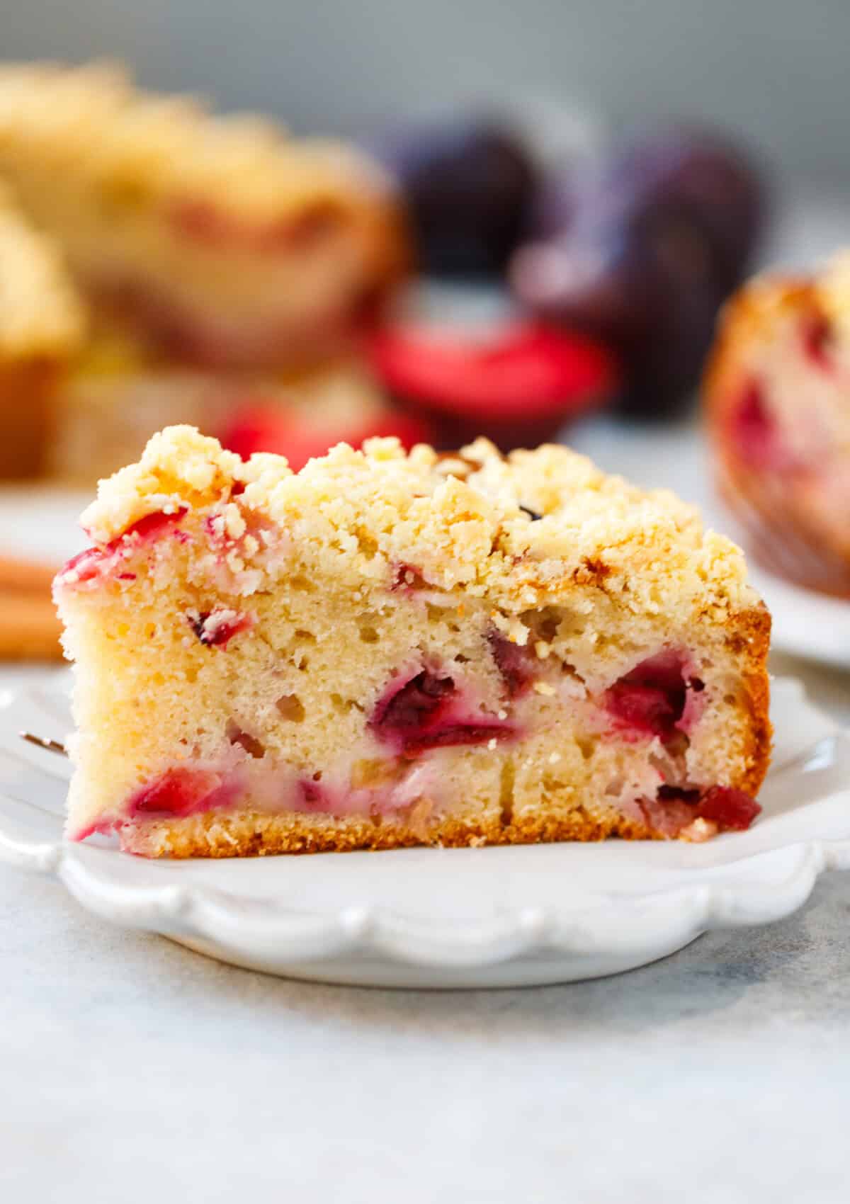 A slice of plum coffee cake in a plate