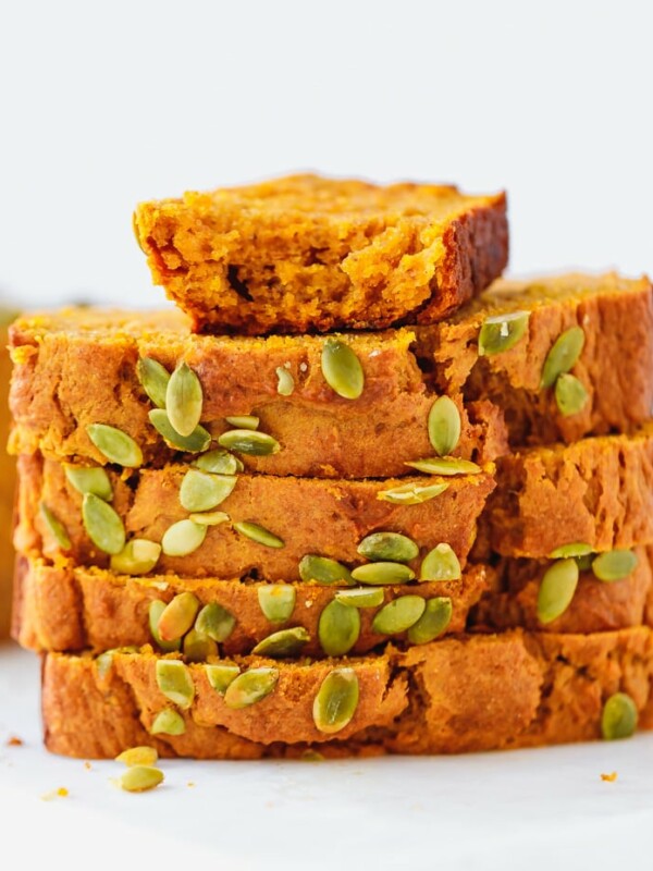 Slices of moist pumpkin bread stacked on top of each other