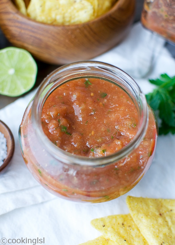 Easy blender salsa in a small glass jar.