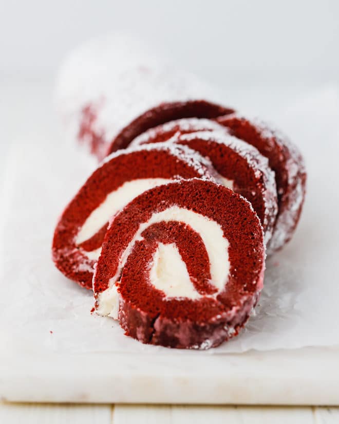 Red velvet cake roll on parchment paper