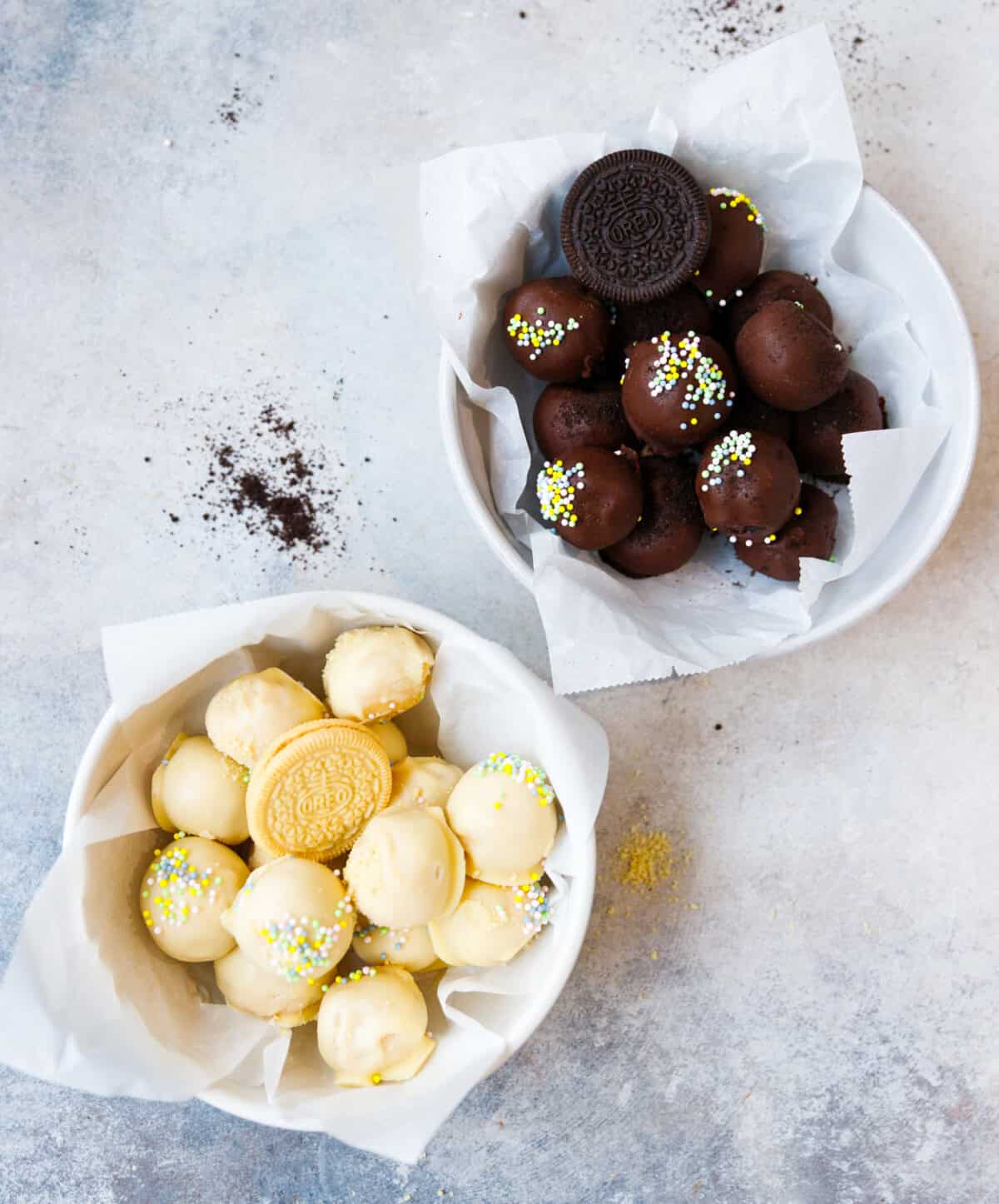 Golden Oreo truffles and chocolate Oreo truffles served in bowls with sprinkles
