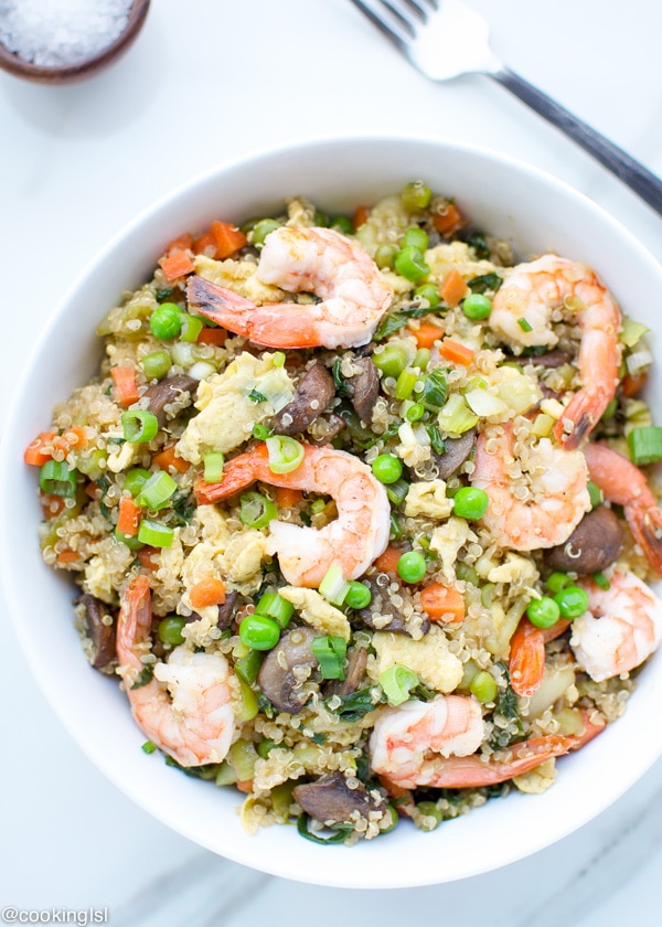Shrimp Fried Quinoa - colorful dish in a white bowl, topped with green onions.