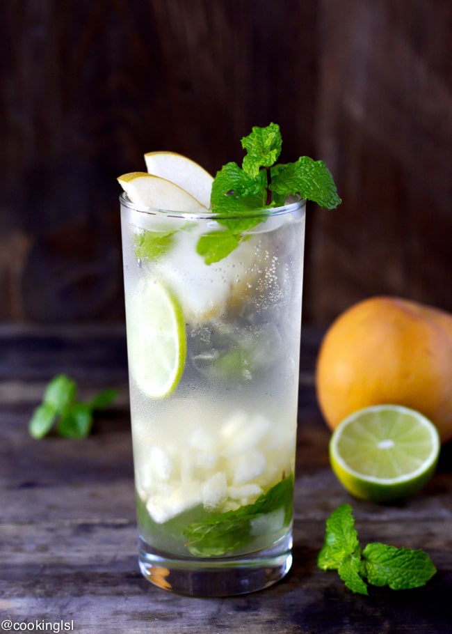 Easy Asian Pear Mojito Recipe. Sparkly drink, in a tall clear glass, topped with pear slices and mint. Made with honey.
