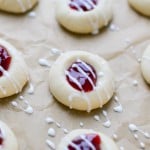 Cherry jam thumbprint cookies on parchment paper