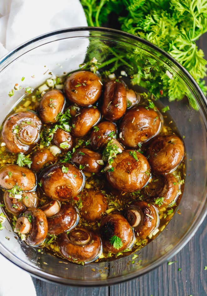 Marinated mushrooms with olive oil, vinegar and herbs on a bowl
