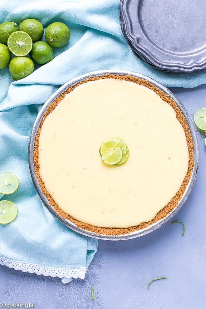 Key Lime Pie Recipe {Lightened Up}. Homemade Key Lime Pie, healthy, easy, impressive and tasty summer dessert. In a tin, topped with key limes and light whipped cream.