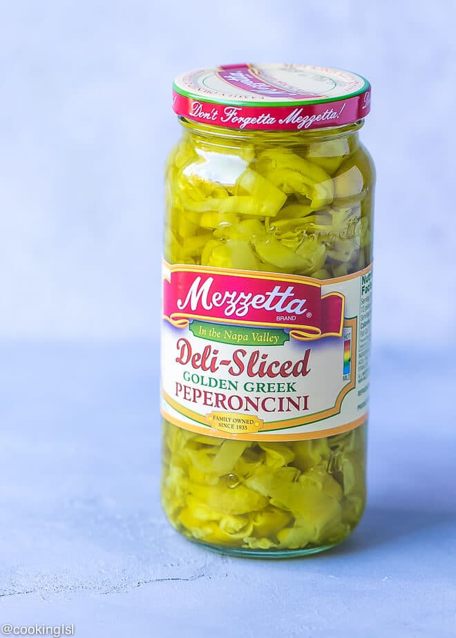 A jar of pickled Mezzetta Peperoncini deli-sliced peppers for a pasta sauce recipe
