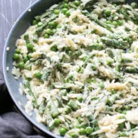 One pan, creamy orzo pasta, made with cream cheese, fresh asparagus, peas, Parmesan, garlic and spices. Weeknight dinner.