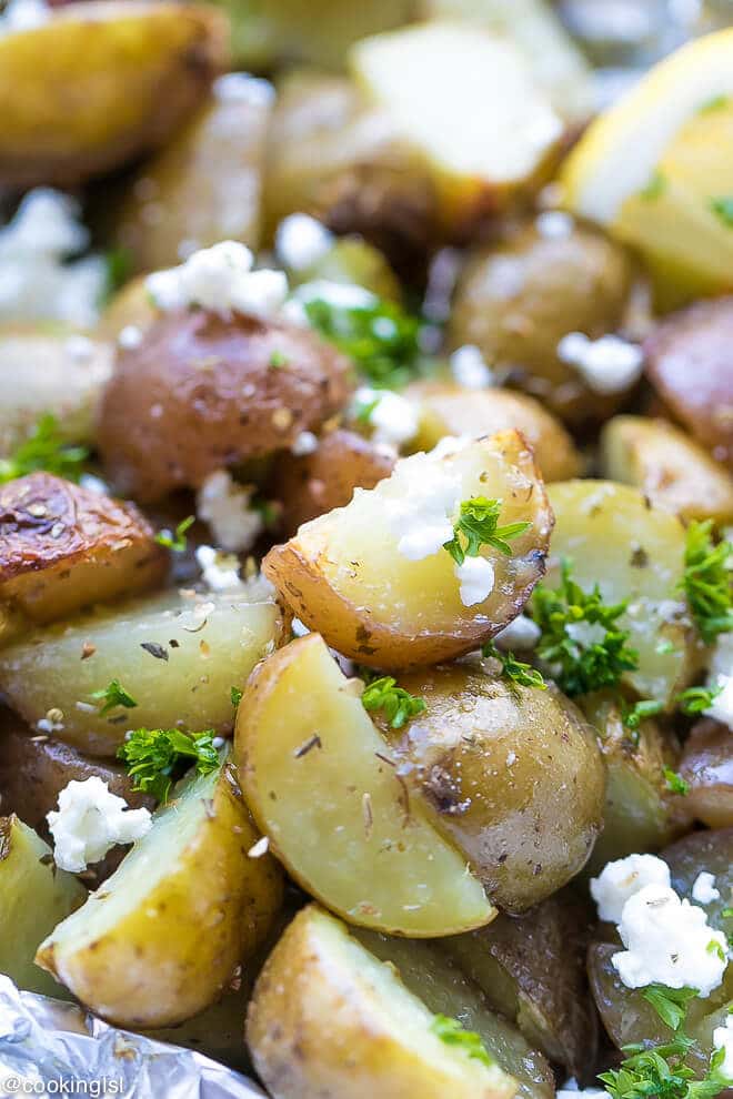 skin on potato pieces in foil in the frill with garlic, parsley, oregano, lemon juice great for summer party food