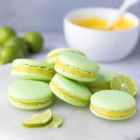 Stack of lime macarons, light green French macarons, filled with lim e curd. Tangy and sweet macarons.