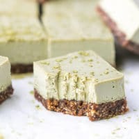 Chunky Bite of Vegan, Raw , clean Matcha Cheesecake Bars, made with coconut cream, Agave nectar, coconut oil, matcha powder and cashews