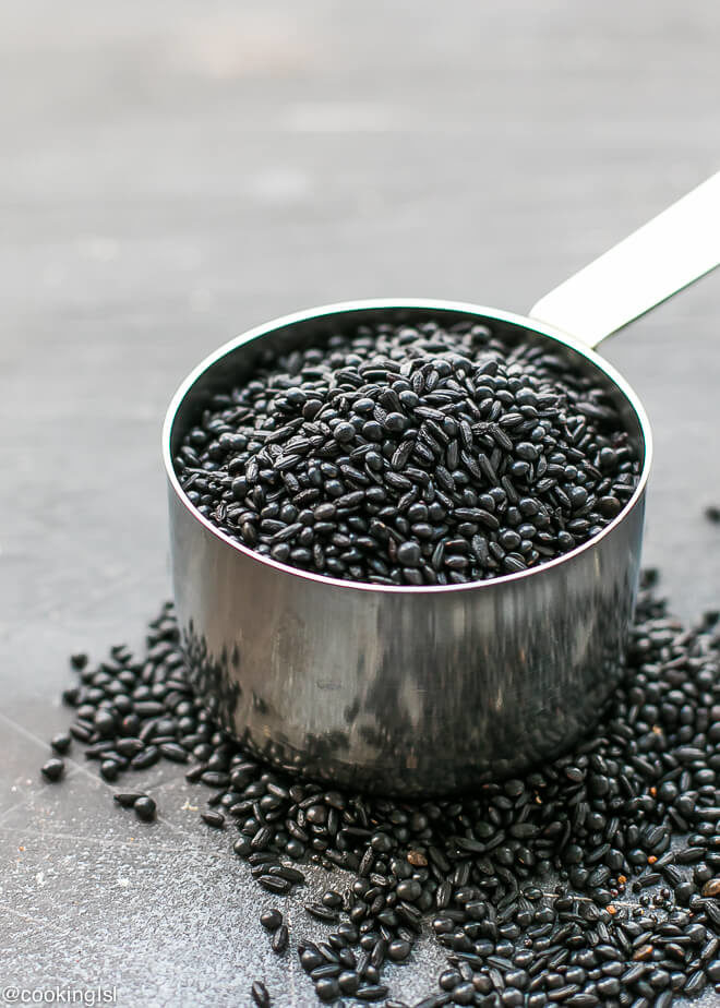 A measuring cup filled with a mix of black rice, quinoa and lentils. Loaded with antioxidants.