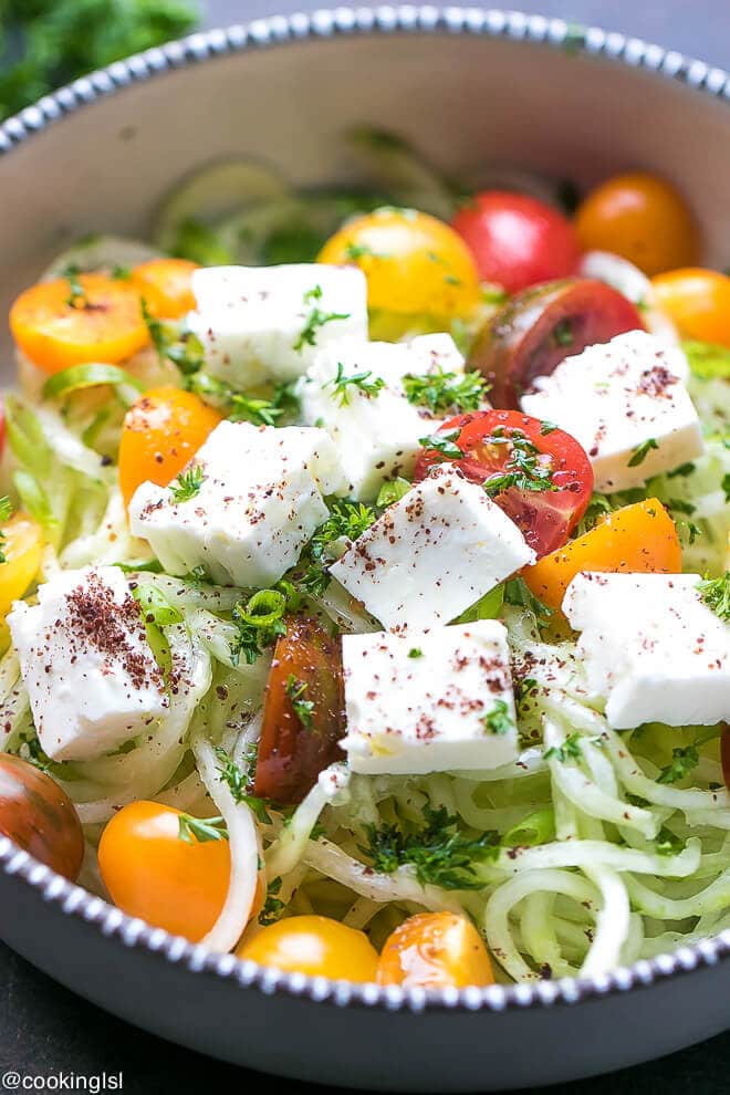 Light, low calorie and delicious Greek, Mediterranean Bulgarian style spiralized cucumber salad with tomatoes and feta.