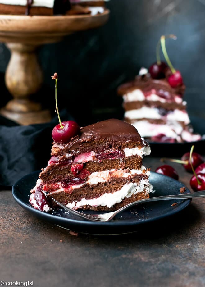 A slice of chocolate cake with whipped cream, cherry filling, cherry liqueur and chocolate ganache made using easy black forrest cake recipe.