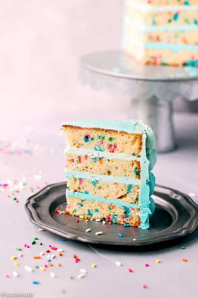 A slice of homemade funfetti birthday cake, with blue ombre buttercream. Baby boy's first birthday smash cake, easy, homemade.