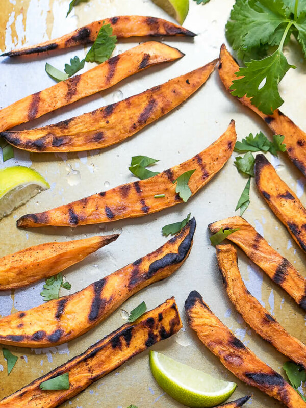 How To Grill Sweet Potato Fries on a servong platter, topped with chopped cilantro and lime juice.