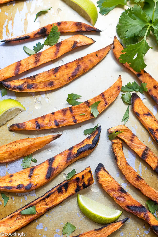 How To Grill Sweet Potato Fries on a servong platter, topped with chopped cilantro and lime juice. 