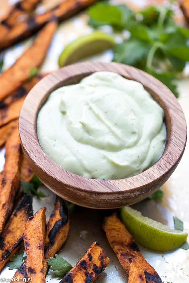 How To Grill Sweet Potato Fries - a wooden dip bowl with healthy avocado yogurt dipping sauce.