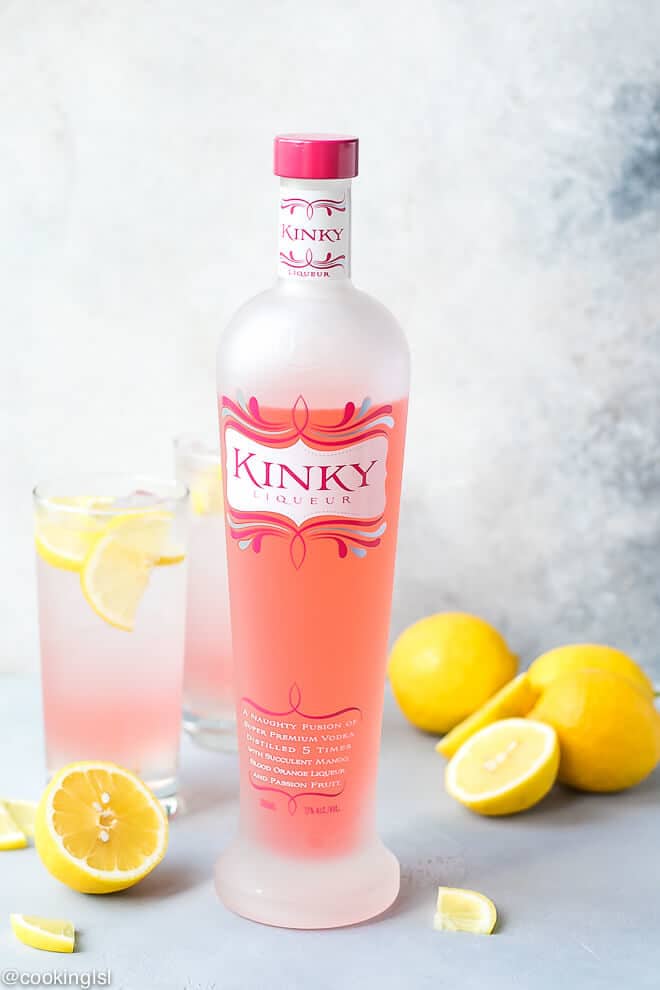 A bottle of pink liqueur. KINKY Pink is delicious tropical fruit fused vodka with flavor notes of mango, blood orange and passion fruit. Perfect for summer cocktails like this Pink Lemonade Vodka cocktail.