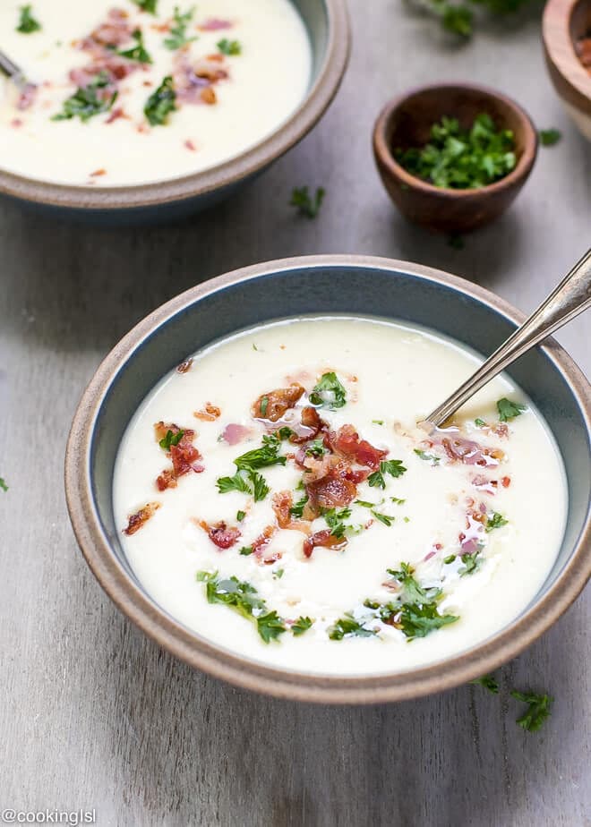 A bowl full with winter soup. A creamic bowl full with warm and comforting Creamy Leek And Potato Soup With Bacon Recipe.