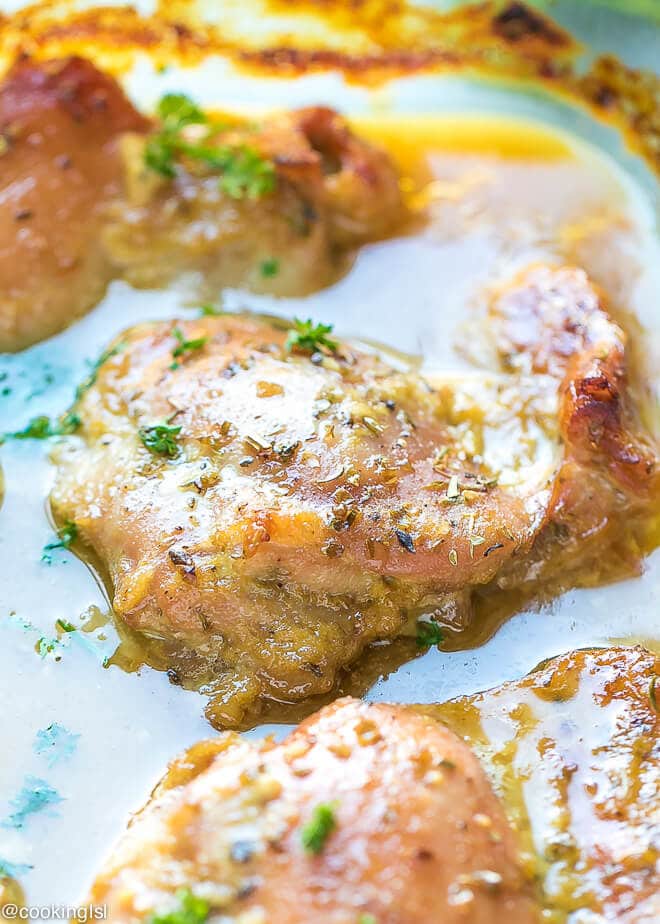 Oven baked honey mustard chicken thighs in a Pyrex baking dish.