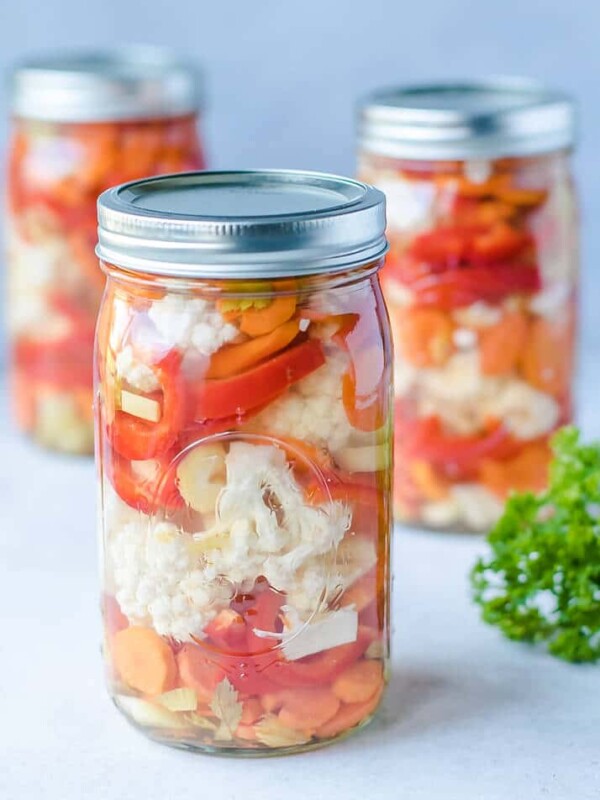 Ball Jars with easy canned vegetables cauliflower, carrots and red peppers recipe. Safe pickling method for crunchy garden vegetables.