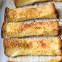 Baked French Toast Sticks Recipe. French Toast Sticks on parchment paper.