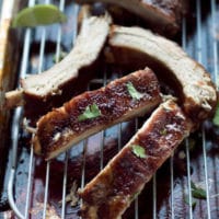 Soy Honey Glazed Pork Ribs Recipe. Smithfield All Natural baby back ribs, brushed with honey soy sauce, cut into pieces. on a wire rack over baking tray, garnished with lime and cilantro.Juicy, sticky, tender. with side of honey sauce