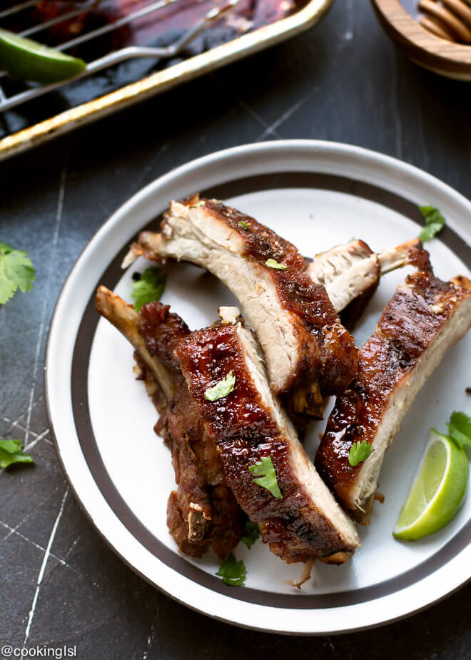 Soy Honey Glazed Pork Ribs Recipe. Smithfield All Natural baby back ribs, brushed with honey soy sauce, cut into pieces. on a plate garnished with lime and cilantro