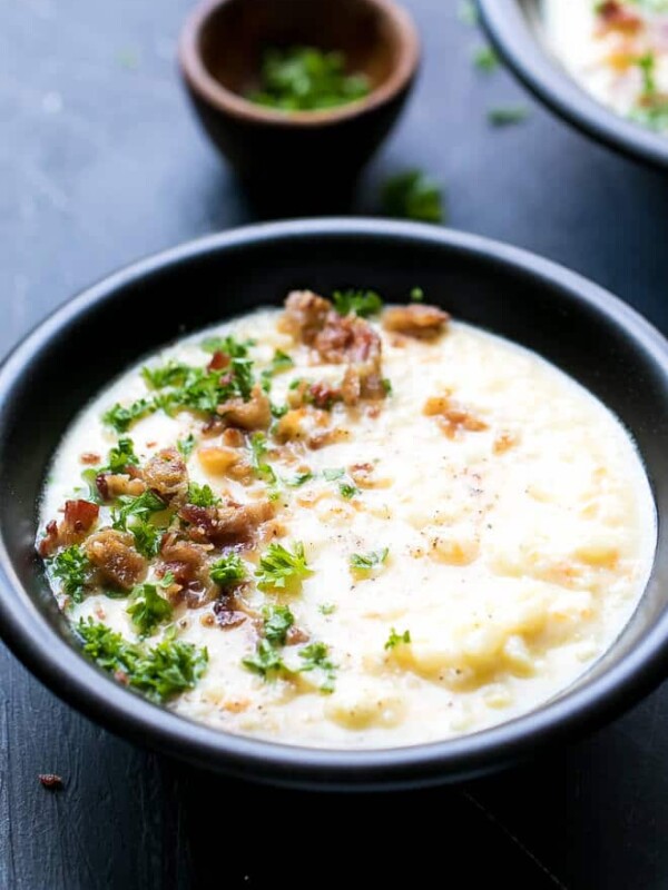 Cauliflower Cheese Soup Low Carb Recipe - creamy, low fat , easy to make, delicious caulidflower cheddar soup in a bowl with parsley on the side.