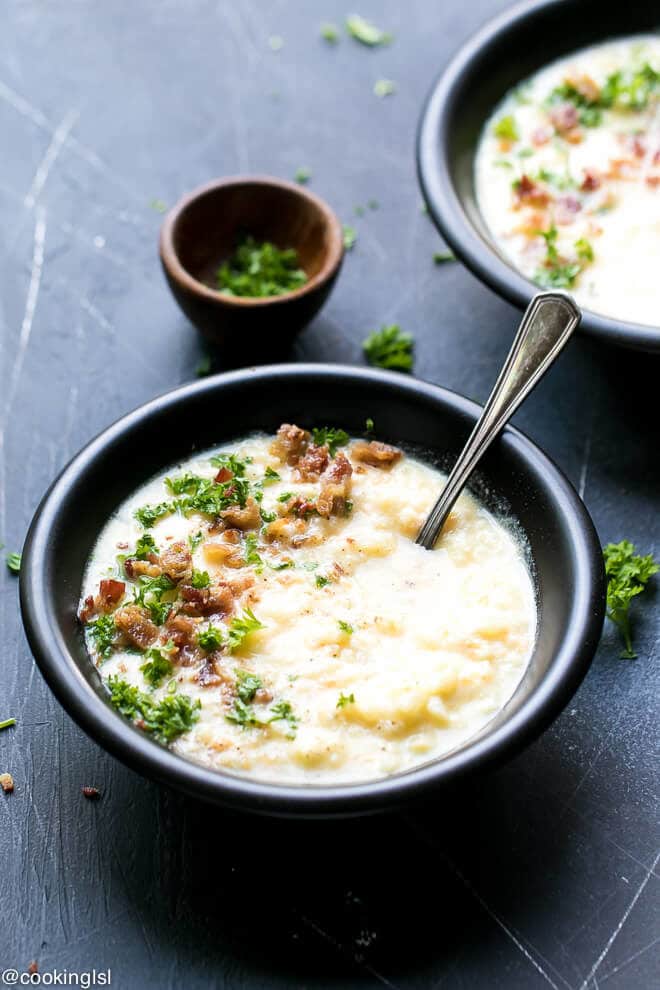 Cauliflower Cheese Soup Low Carb Recipe, Bowl full with cauliflower cheddar soup, topped with chopped parsley and chopped bacon.