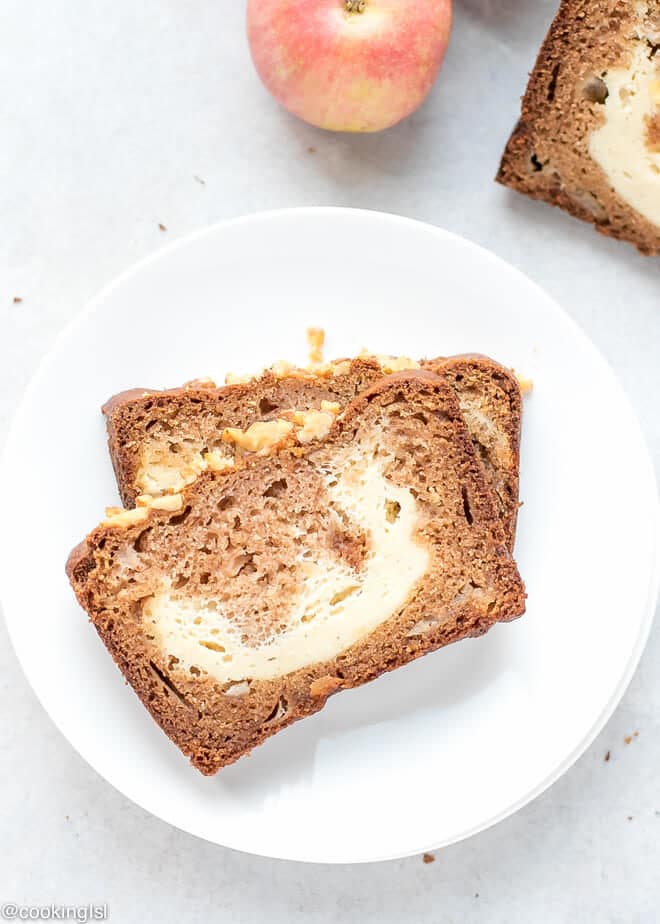 Cream Cheese Filled Apple Bread Recipe -slices of moist apple bread on a cutting board. Two slices of cheesecake bread.