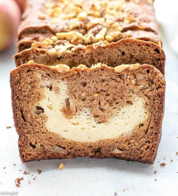 Cream Cheese Filled Apple Bread Recipe -slices of moist apple bread on a cutting board. The perfect slice and apples on the side.