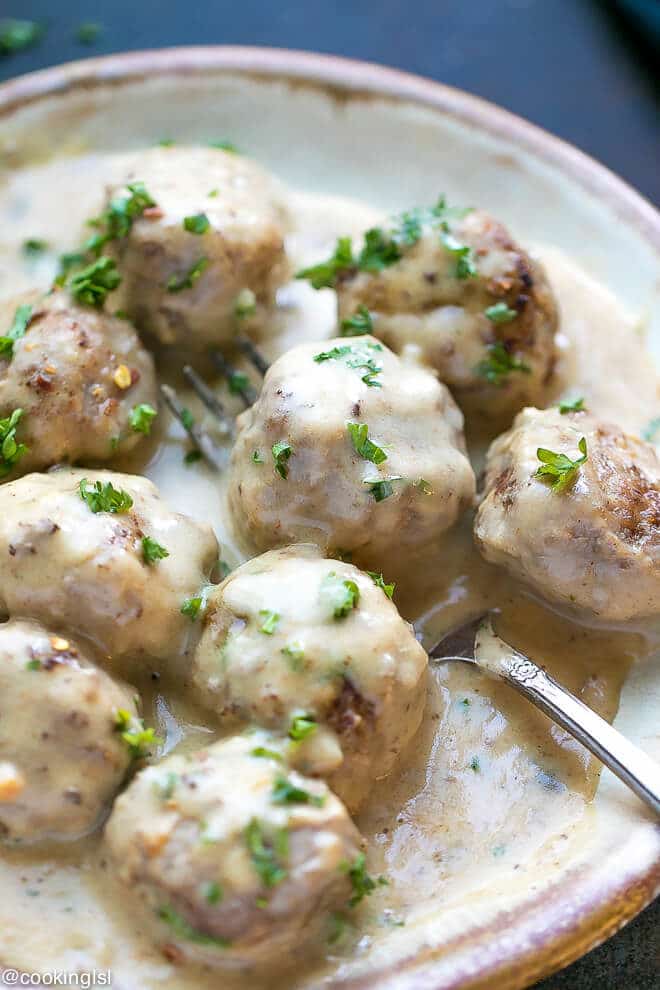 Meatloaf Meatballs With Creamy Sauce Recipe- small meatballs on a plate with a fork.