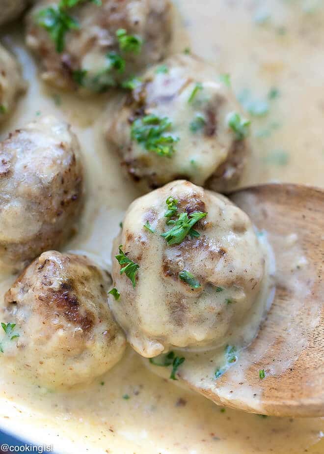 Meatloaf Meatballs With Creamy Sauce Recipe- small meatballs in a pan, topped with parsley.