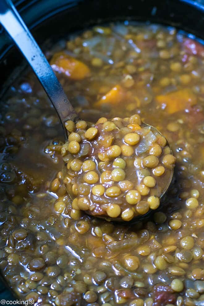 Sweet Potato Lentil Chili Recipe - crock pot full with lentil soup and a ladle scooping soup.
