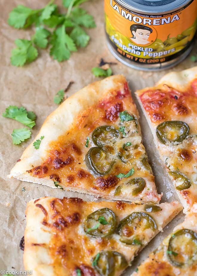 Canned Jalapeno Pizza Recipe - cheesy pizza, thin crust, topped with LA MORENA® Jalapeños and can on the side.